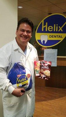 Dr. Estrella posing with some of the food collected by our office for the interfaith food pantry collection in November