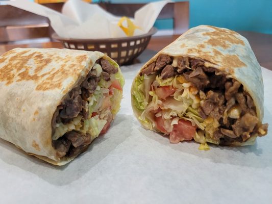 Burrito carne asada (skirt steak) with lettuce, tomatoes and beans