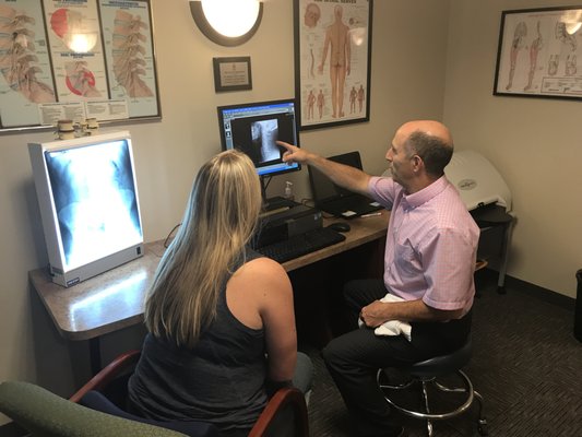 Dr. Davidson reviewing a digital foot scan and x-ray with a patient