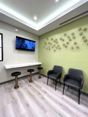 Waiting room with stools for extra seating and area for kids to do their after school homework.