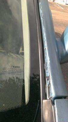 Windshield trim showing meared adhesive.