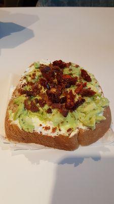 The AVO...sourdough toast with avocado, bacon, cream cheese, and sundried tomato!