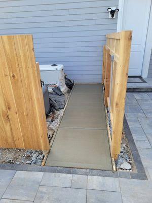 Concrete pathway to allow for garbage can storage.