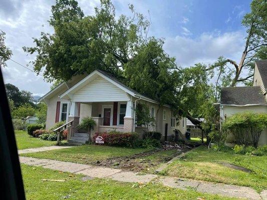 Working hard to remove a tree off of the roof after high winds hit Union City Tennessee