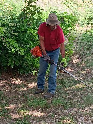 Cleaning up the yard removing all junk and cutting grass