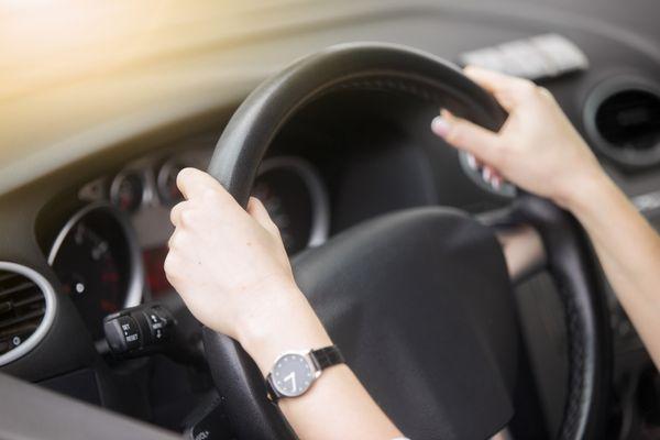 Student holding a steering wheel