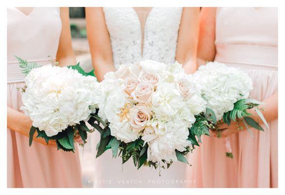 Romantic bridal bouquet and bridesmaids to compliment.