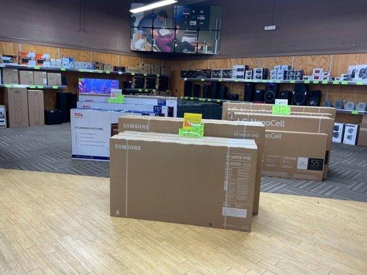 Image showing TVs within their packaging sitting on the sales floor