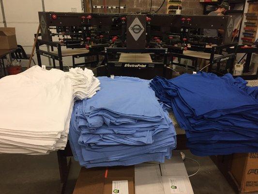 Shirts stacked ready to print at talkingink custom t-shirts.