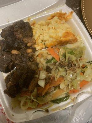 Oxtails with macaroni and cheese and cabbage