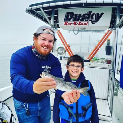 Captain Mike educating Jack about this weakfish he reeled in!