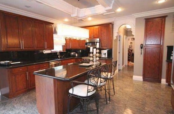 CHANDELIER ABOVE KITCHEN ISLAND AND RECESSED LIGHTING