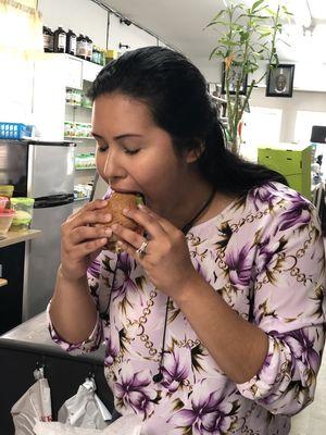 A satisfied customer enjoying one of our tasty Vegan Burgers.