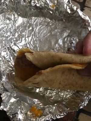 Hard, greasy and old, stale bean and cheese taco.