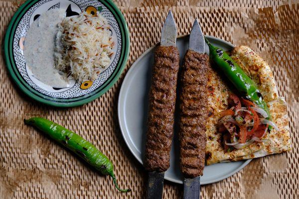 KEBAB with rice, tomato & onion salad, grilled pepper, tzatziki, pita