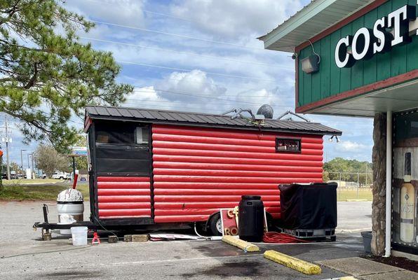 Cute little coffee truck next to a less cute liquor store