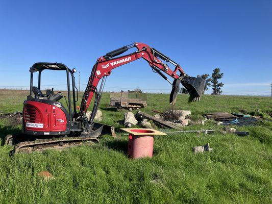 Using heavy equipment to remove concrete.