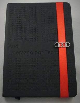 Custom designed promotional items. Journal with deboss logo pattern and custom metal bookmark.