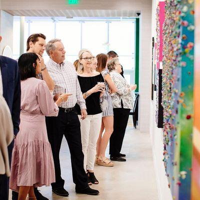 Partygoers enjoying the artwork at the ALG Collective Grand Opening Party.