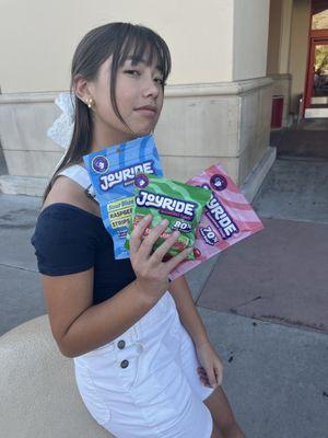 An amazing girl outside an AMAZING store, holding amazing things.