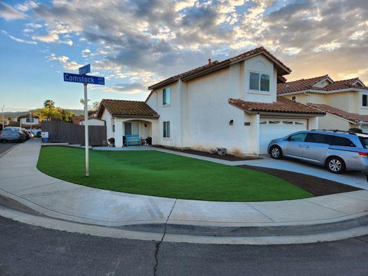 Artificial turf and concrete installed in our front yard to extend the patio and drive and provide a large amount of play space for the kids