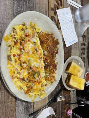 The Ultimate Omelette with crispy hash browns and toast.