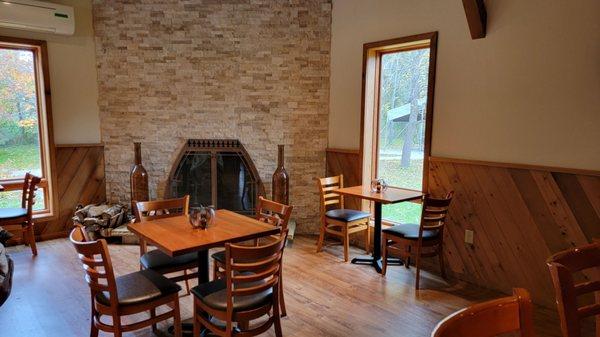 Tables by the fireplace, and nice outdoor fall views.