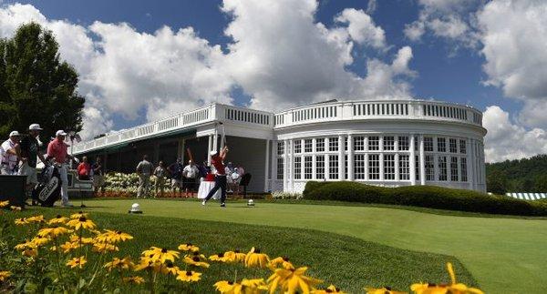 Bryson DeChambeau tees off next to The Greenbrier clubhouse.