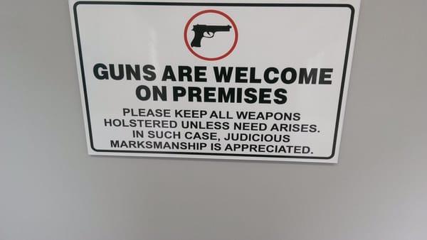 The funniest guns welcome sign I have ever seen at a business.