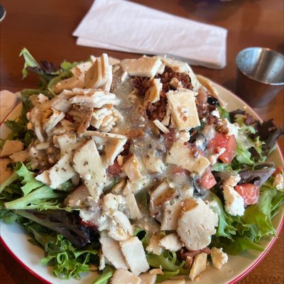 Greek salad with chicken and bacon.