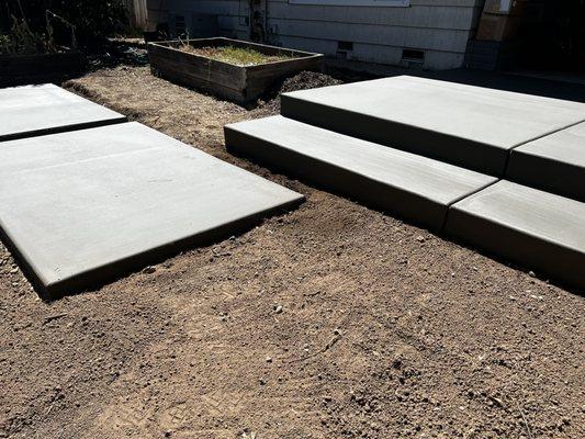 Partial view of new patio and large pavers shortly after forms were removed, but before addition of new plants