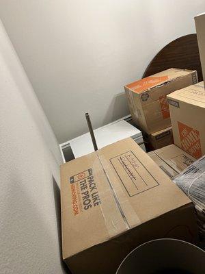 Boxes busted open after being laid sideways with heavier boxes on top