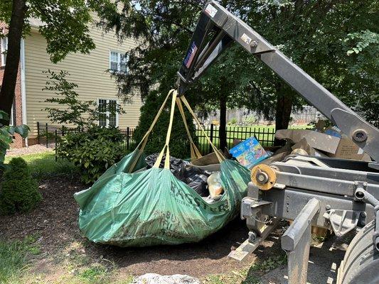 Lifting a Bagster to remove it from the property.