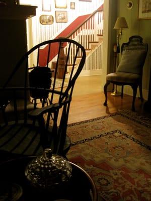 view from darkened living room into main foyer