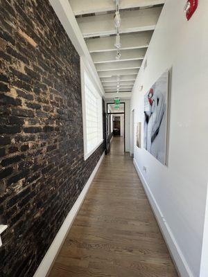 We are located in a nearly 100 year old building with beautiful exposed brick walls.