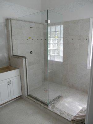 A custom splashguard for a shower enclosure.