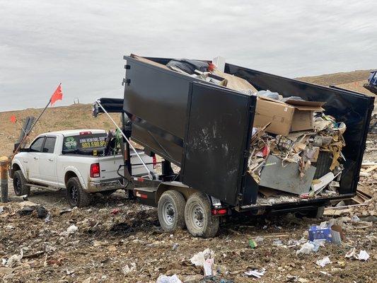 At the landfill dumping trash