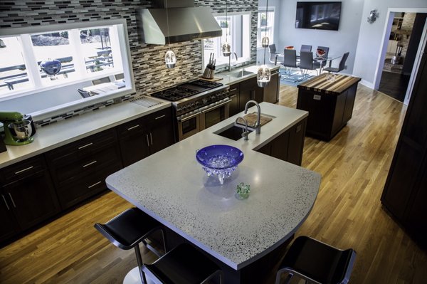 One piece concrete island with custom drain board with rails for a cutting board.  Exposed aggregate detail along seating area edge