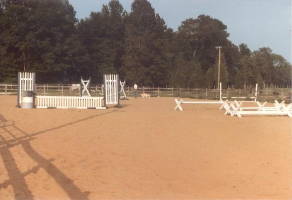 100' x 200' ring with various jump standards, barrels, cavaletti, extra poles and is at night.