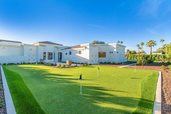 Custom putting green right in the backyard, one of many outdoor amenities in this family friendly backyard landscape.