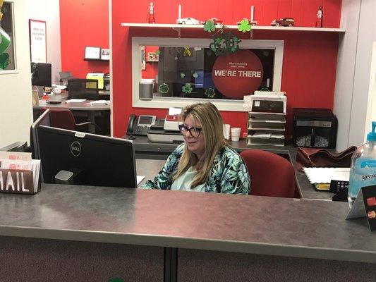 Natalie working at the front desk.