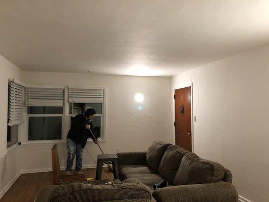 "After" photo of living room painted by CVC, Swiss coffee walls and twinkling lights ultra white ceiling.