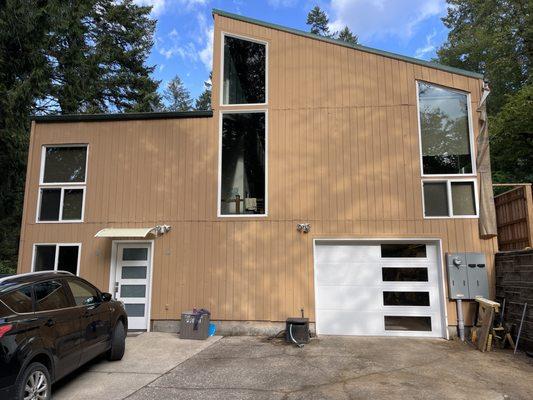 He installed this contemporary flush garage door with vertical windows to compliment the entry door.