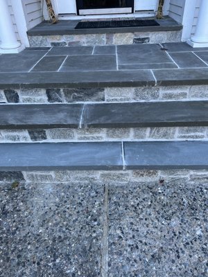 The second time Melgar Masonry fixed the steps: the first step is a different color than other steps and uneven grout lines.