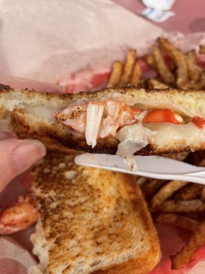 Lobster grilled cheese with Gruyère and fries.