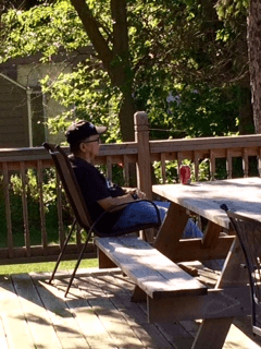 Jimmy sitting on his back porch.  Jimmy has a brain injury and requires 24-hour assistance.