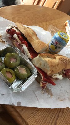 Fresh mozzarella, prosciutto , roasted pepper on a seeded. Pepper shooters and a limonata San pellegrino.