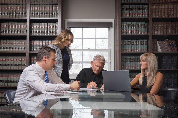 Joe Roark, Teris Swanson, Mark Bryant and Emily Roark preparing for a criminal case.