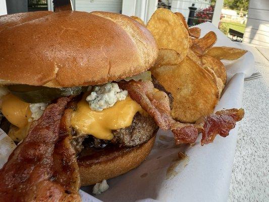 Black and blue burger with homemade chips.