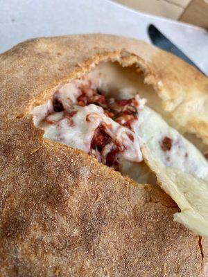 Calzone with artichoke heart, mushrooms, black olives and spinach